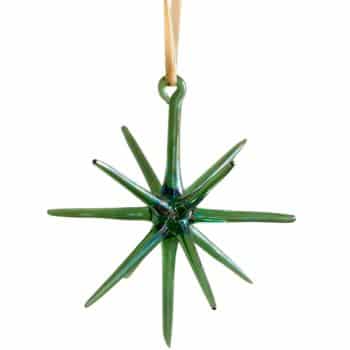 Green blown glass star Christmas ornament hanging from a cream ribbon.