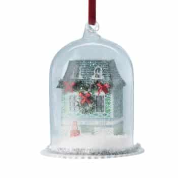 Miniature Christmas house ornament inside a clear glass cloche.