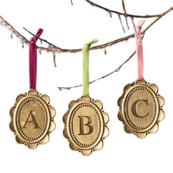 Gold oval monogram Christmas ornaments with A, B, and C initials.