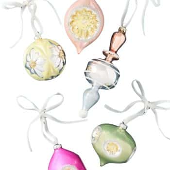 Pink, yellow, green, and silver glass Christmas ornaments tied with white ribbons.