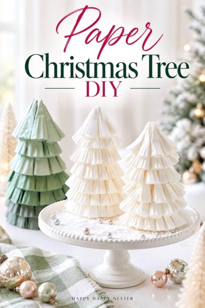Handmade paper Christmas trees made from folded green and white cupcake liners, displayed on a white cake stand.