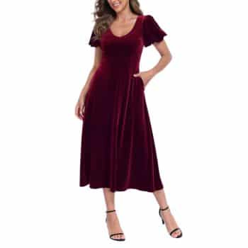 Burgundy velvet midi dress with a V-neckline, short puff sleeves, fitted waist, and flowing skirt, styled with black heels.