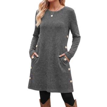Charcoal gray ribbed tunic dress with long sleeves, round neckline, side buttons, and pockets, paired with black leggings and brown boots.