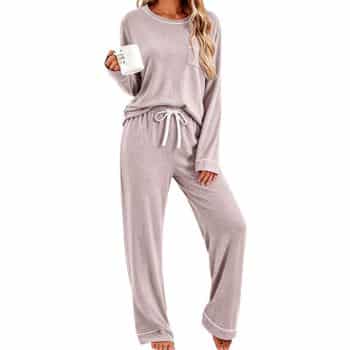 Soft mauve two-piece pajama set with a long-sleeve crewneck top, white piping, chest pocket, and matching drawstring pants.
